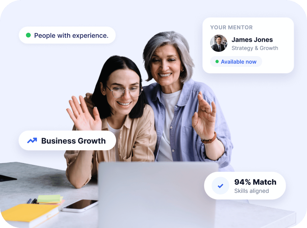 Two business owners wave on a video call with their mentor.