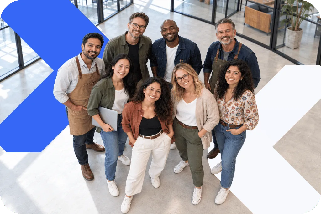 A group of smiling business owners standing together, seen from above