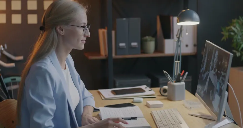 A business owner takes notes during a virtual mentoring call